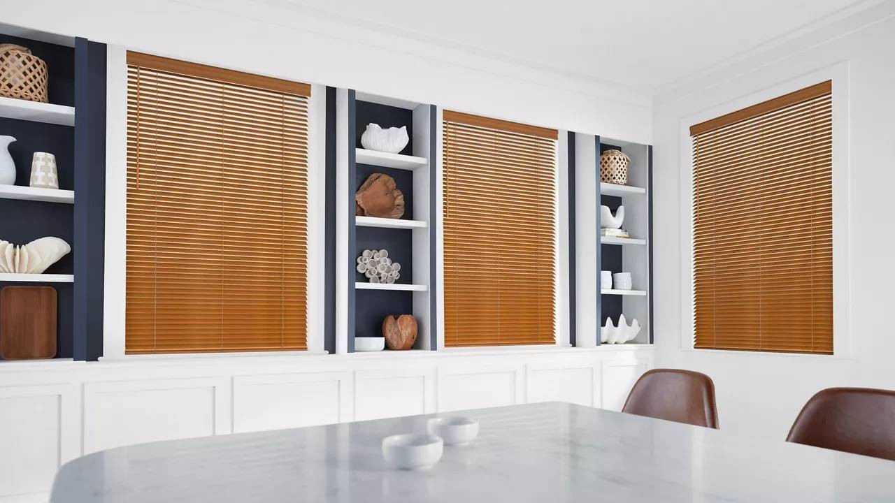 Hunter Douglas Everwood® Faux Wood Blinds introduce color to a neutral dining room in Bloomington, IL
