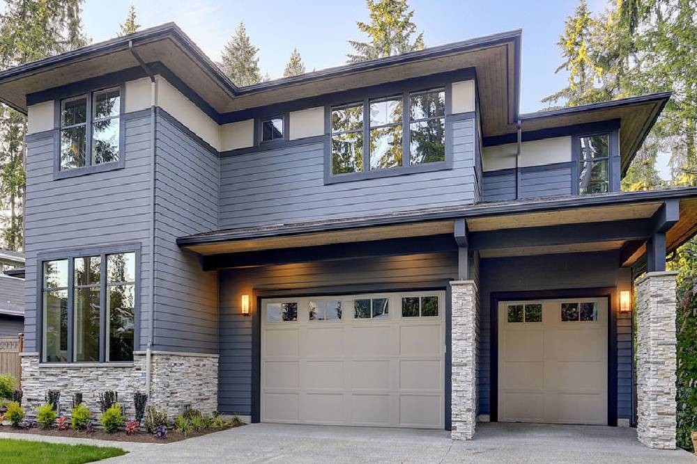 An exterior photo of a single family residential home with reflective silver window film